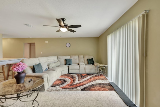 carpeted living room featuring ceiling fan