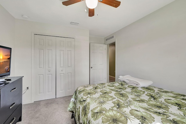 bedroom featuring light carpet, a closet, and ceiling fan