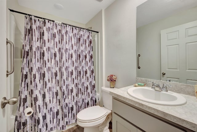 bathroom with vanity, a shower with shower curtain, and toilet