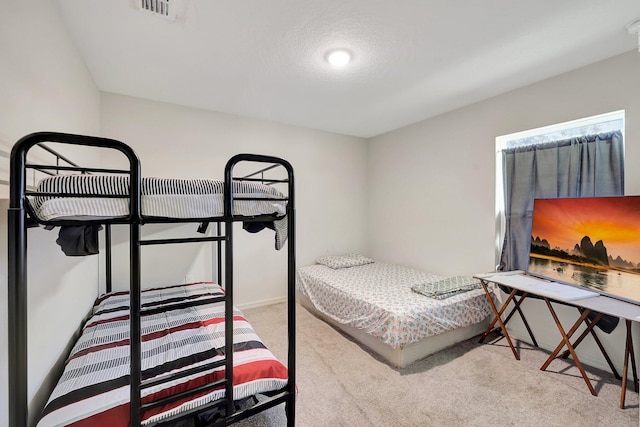 bedroom with carpet and a textured ceiling