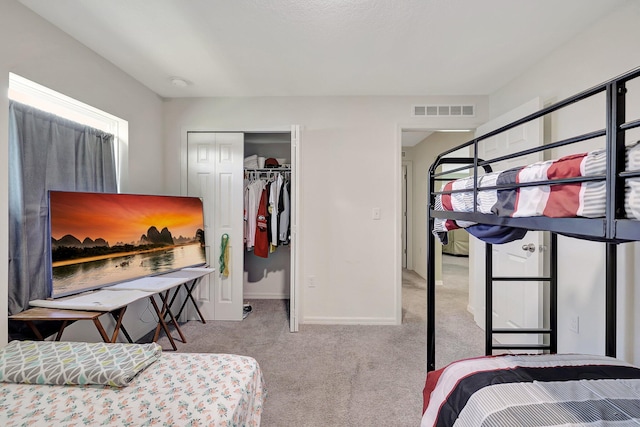 carpeted bedroom with a closet