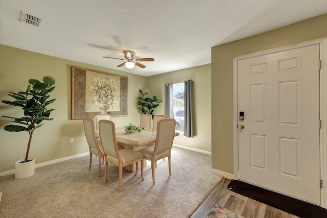 dining room featuring a textured ceiling, hardwood / wood-style flooring, and ceiling fan