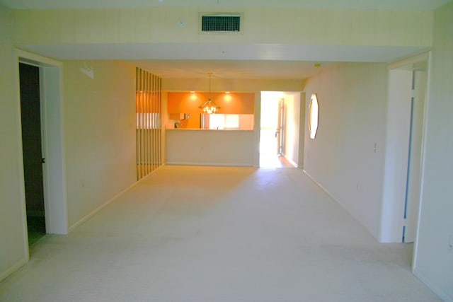 unfurnished living room featuring light colored carpet