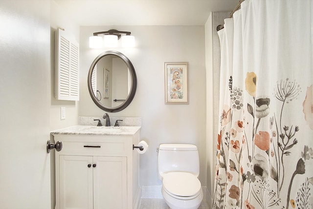 bathroom with toilet, curtained shower, vanity, and tile patterned floors