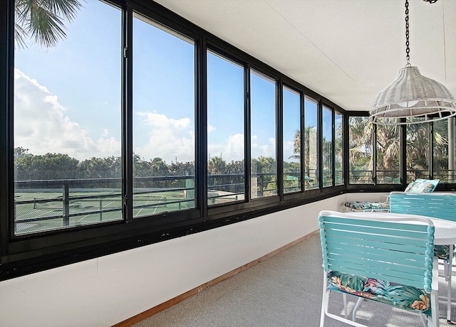 sunroom featuring a jacuzzi