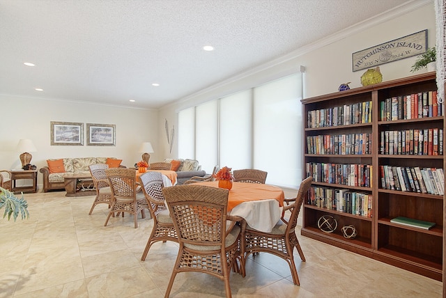 dining space featuring ornamental molding and a textured ceiling