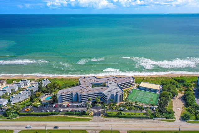 birds eye view of property featuring a water view and a beach view