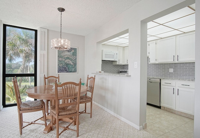 dining room with a textured ceiling, a chandelier, and light tile patterned flooring