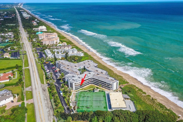 bird's eye view featuring a water view and a beach view