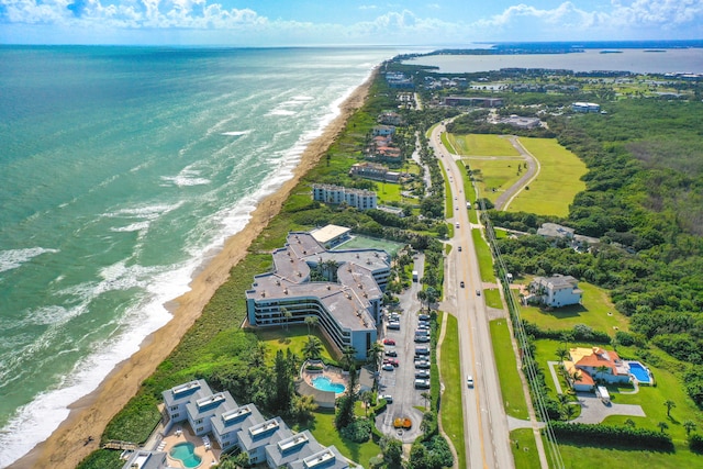 bird's eye view with a water view and a beach view