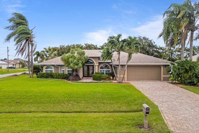 view of front of property with a garage and a front lawn