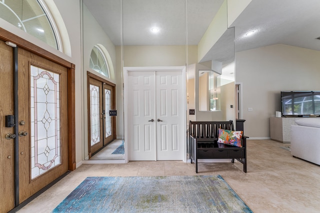 tiled entrance foyer with french doors and vaulted ceiling