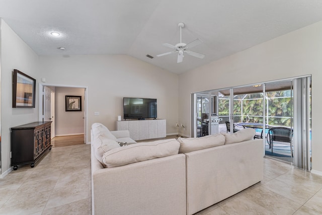 living room with a textured ceiling, high vaulted ceiling, and ceiling fan