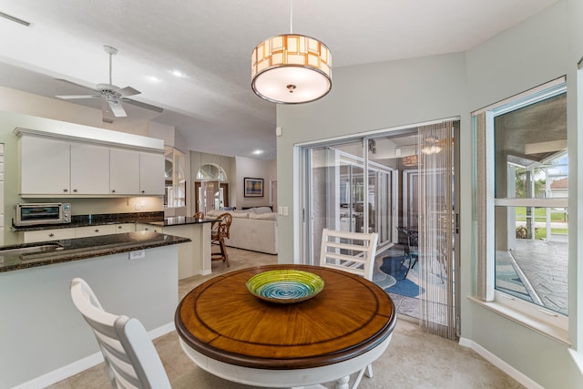 tiled dining space with ceiling fan