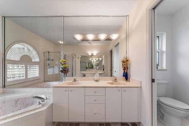 full bathroom featuring toilet, vanity, and separate shower and tub