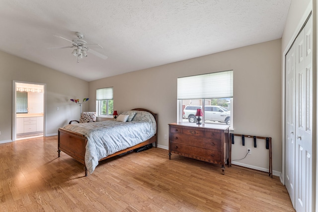 bedroom featuring a closet, ceiling fan, a textured ceiling, and light wood-type flooring