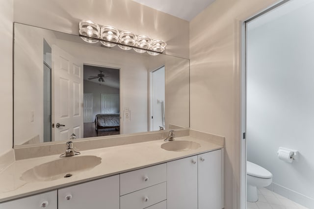 bathroom featuring toilet, ceiling fan, tile patterned floors, vaulted ceiling, and vanity