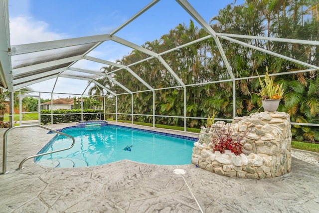 view of pool with a patio and glass enclosure