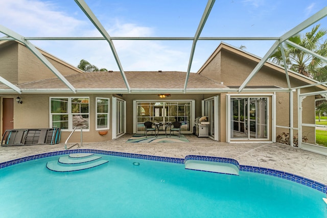 view of pool featuring a patio and glass enclosure