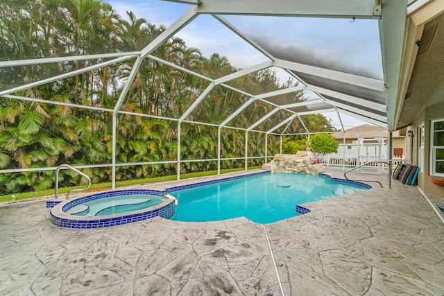 view of swimming pool featuring a patio, a lanai, and an in ground hot tub