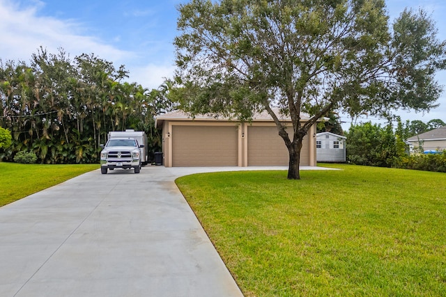 view of front of house with a front yard and a garage