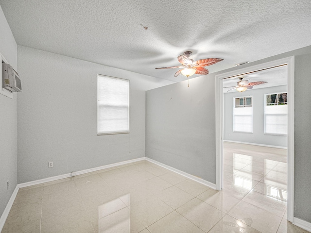 unfurnished room featuring ceiling fan, a textured ceiling, and light tile patterned floors