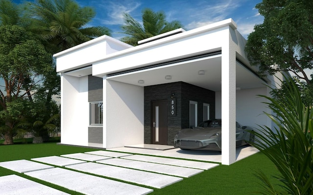 533 NW 16th Ave, Fort Lauderdale, FL 33311 - rear view of house featuring stone siding, stucco siding, and a lawn