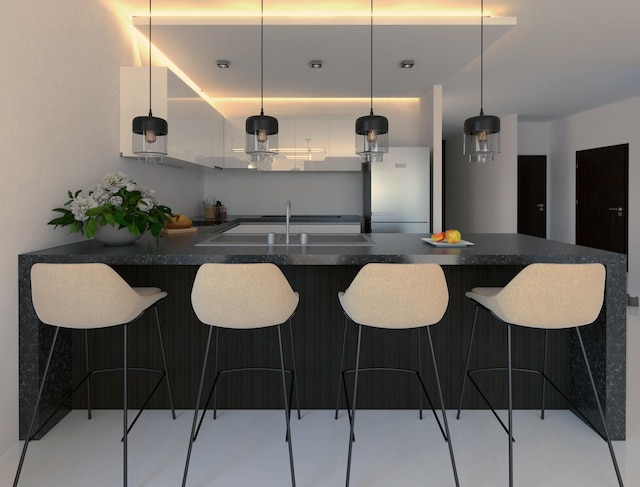 533 NW 16th Ave, Fort Lauderdale, FL 33311 - kitchen with dark countertops, decorative light fixtures, a kitchen breakfast bar, freestanding refrigerator, and a sink