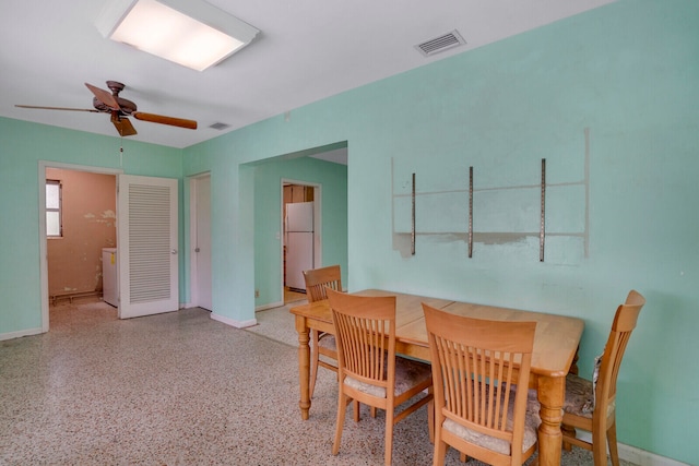 dining area featuring washer / dryer and ceiling fan