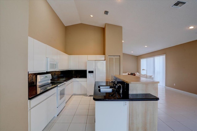 kitchen with sink, a kitchen island, lofted ceiling, white appliances, and white cabinets