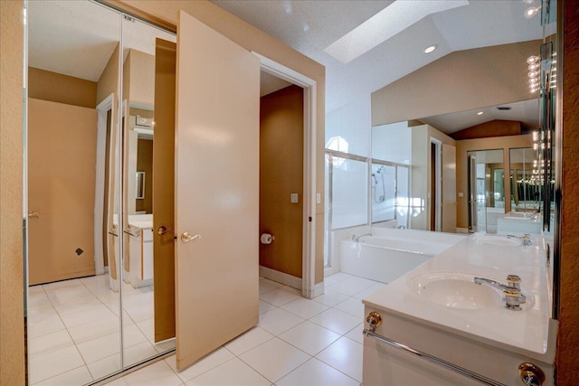 bathroom with tile patterned floors, vaulted ceiling with skylight, a textured ceiling, vanity, and independent shower and bath