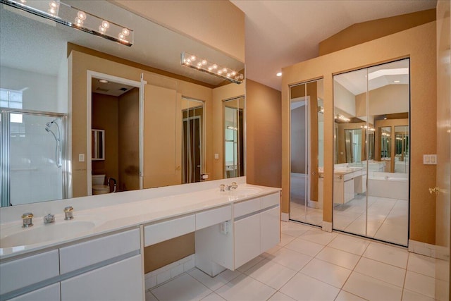 full bathroom with tile patterned floors, vanity, shower with separate bathtub, toilet, and lofted ceiling