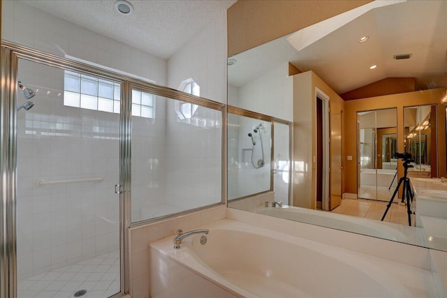 bathroom with tile patterned flooring, shower with separate bathtub, a textured ceiling, and lofted ceiling