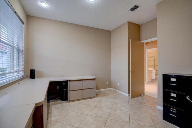 office area featuring light tile patterned floors and a textured ceiling