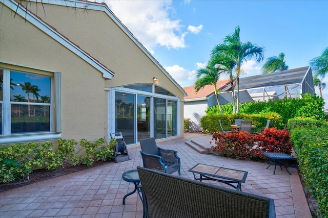 view of patio / terrace featuring glass enclosure