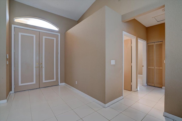 tiled foyer featuring lofted ceiling