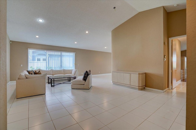 living room with light tile patterned floors, a textured ceiling, and vaulted ceiling