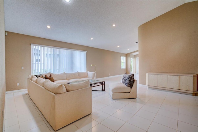 tiled living room featuring vaulted ceiling and a textured ceiling