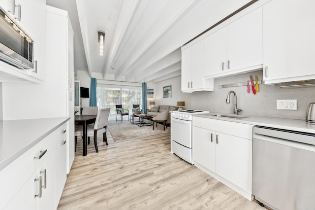 kitchen with white cabinetry, stainless steel appliances, sink, and light hardwood / wood-style flooring