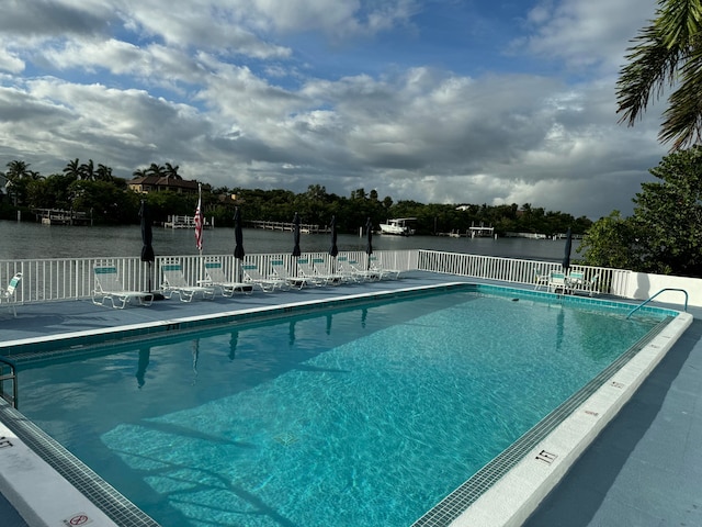 view of pool with a water view