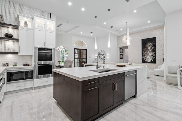 kitchen with stainless steel double oven, dark brown cabinets, sink, decorative light fixtures, and white cabinets