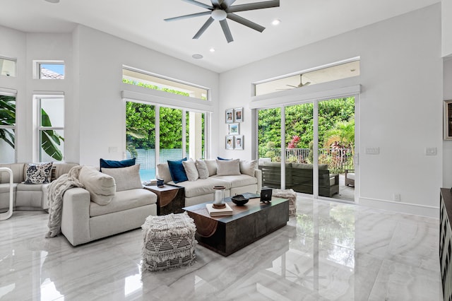 living room featuring a high ceiling and ceiling fan