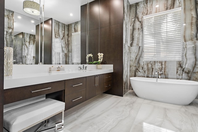 bathroom featuring tile walls, vanity, and a bathtub