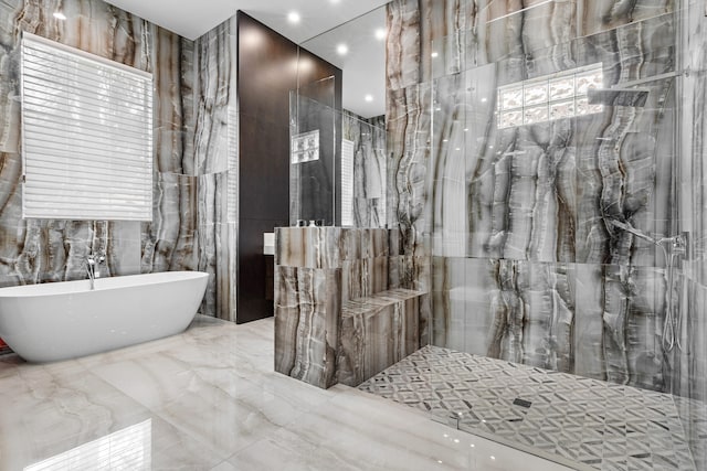 bathroom featuring a wealth of natural light, tile walls, and shower with separate bathtub