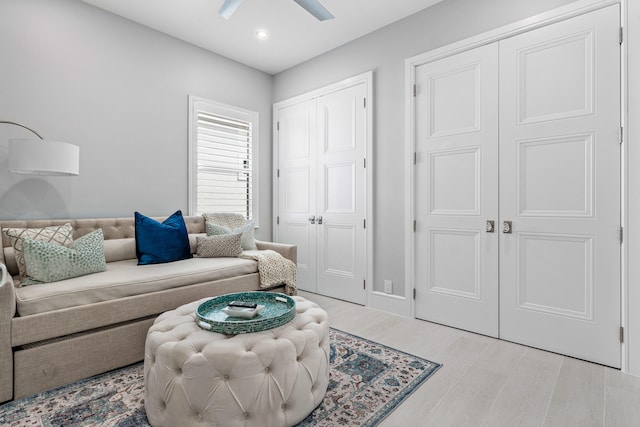 living room featuring ceiling fan and light hardwood / wood-style flooring