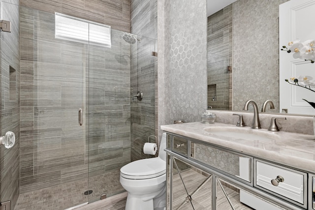 bathroom with vanity, toilet, and walk in shower