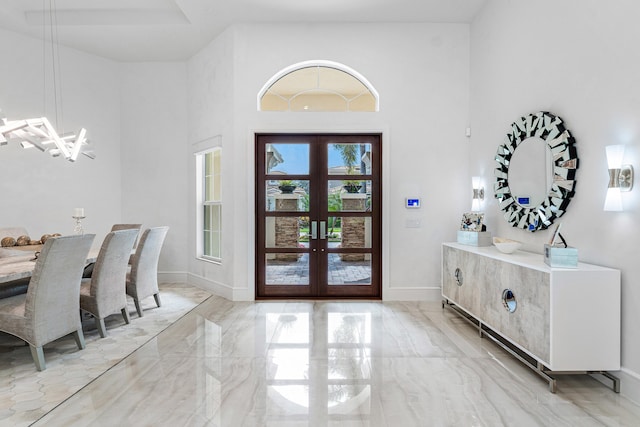 entryway with french doors and a high ceiling