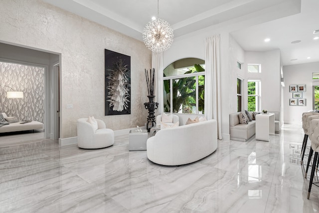 living room with a notable chandelier and a raised ceiling