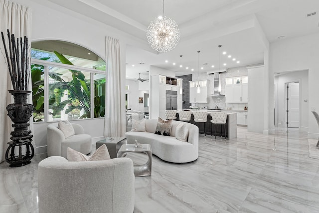 living room with ceiling fan with notable chandelier