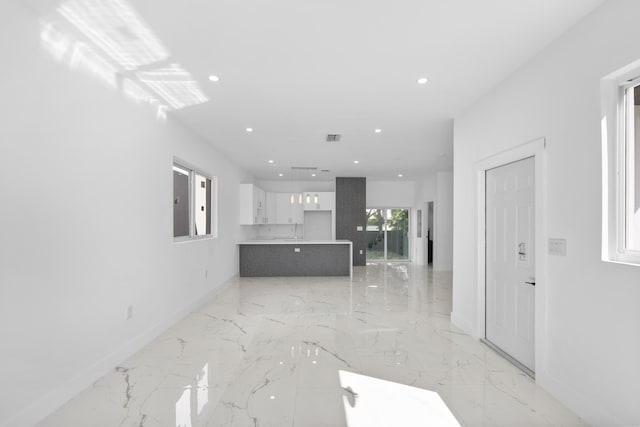 unfurnished living room featuring sink